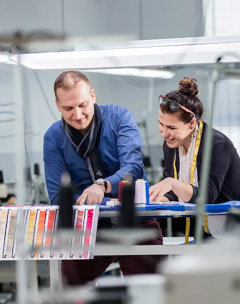 Two manufacturing colleagues setting a machine