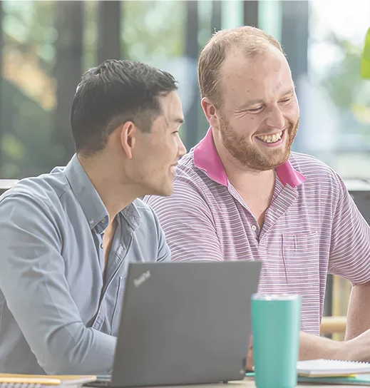 Two recruitment specialists reviewing a list of candidates